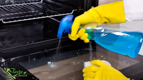 Applying baking soda paste to dirty oven interior