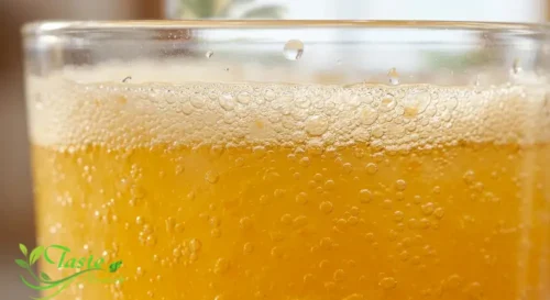 Close-up of fine carbonation bubbles in fresh orange juice