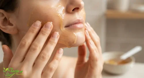 Close-up of hands applying a thin layer of honey face mask to clean skin