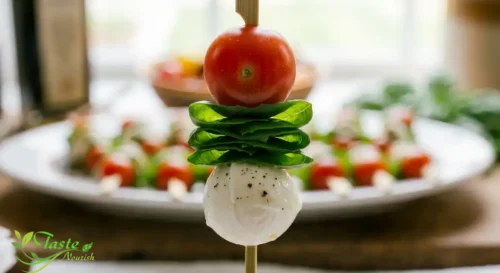 No-Cook Caprese Skewers Recipe: Folded basil leaf threaded between tomato and mozzarella on a skewer