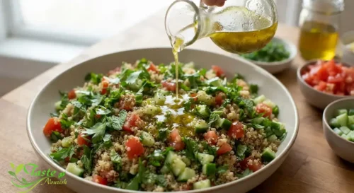 Lemon and olive oil dressing being poured over quinoa tabbouleh salad