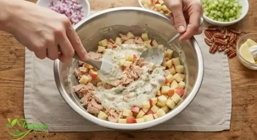 tuna and diced apple in a mixing bowl