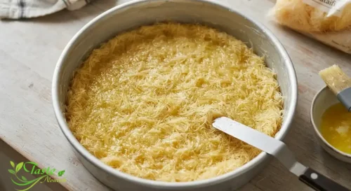 Butter-coated shredded kataifi dough pressed into a pan before baking